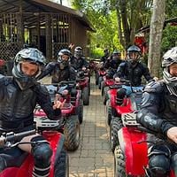 Quad bike riding adventure in lush tropical forest Thailand.
