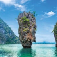 Stunning limestone karst formations rising from turquoise waters in Phuket, Thailand.