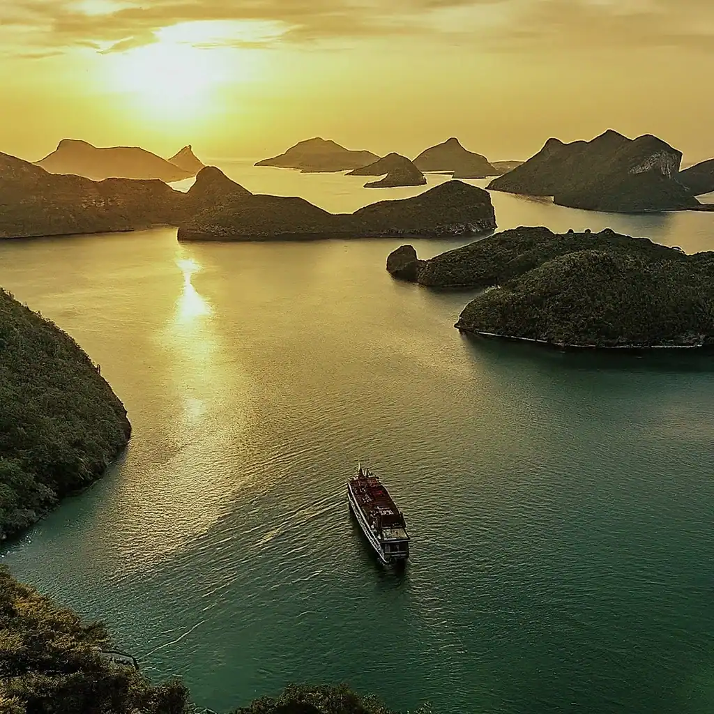Exploring Angthong National Marine Park by Big Boat: A Seafarer's Paradise 2 Majestic islands and calm waters in Thailand during sunset, ideal for travel and exploration.